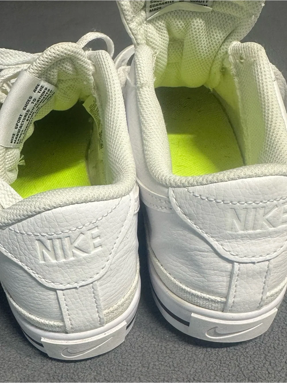 Nike White Mid-Top Sneakers with Orange Swoosh
